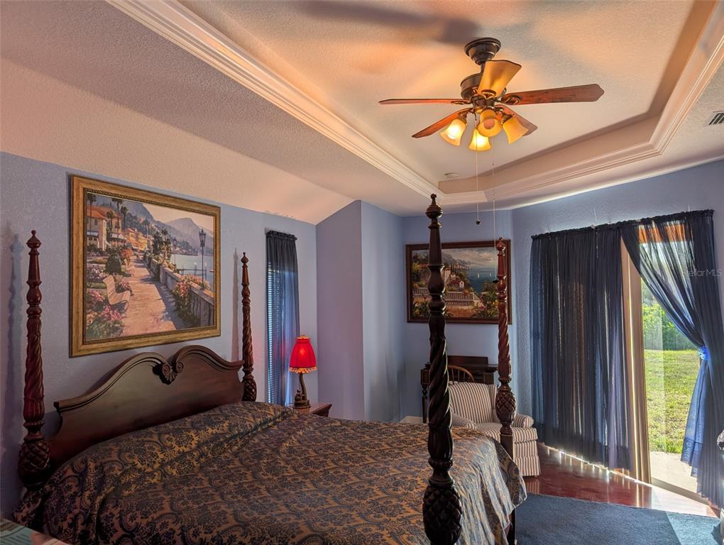 8511 Austrian Boulevard Punta Gorda, FL 33982 - Photo 16 of 20 a bedroom with a bed and a chandelier