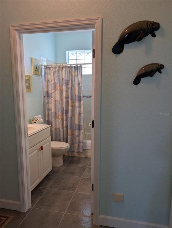 8511 Austrian Boulevard Punta Gorda, FL 33982 - Photo 19 of 20 a bathroom with a granite countertop sink a toilet and shower