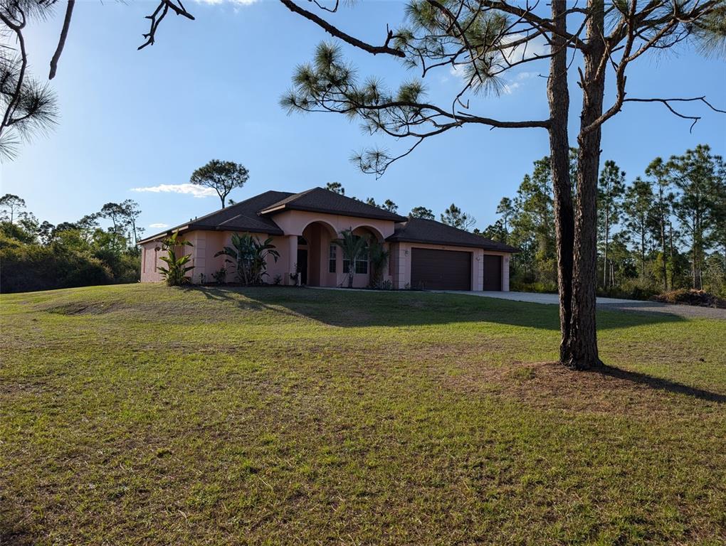 8511 Austrian Boulevard Punta Gorda, FL 33982 - Photo 2 of 20 a house view with a garden space