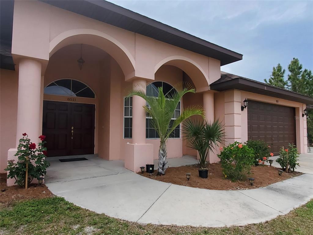 8511 Austrian Boulevard Punta Gorda, FL 33982 - Photo 3 of 20 a front view of a house with garden