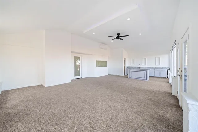 a view of empty room with cabinet and ceiling fan