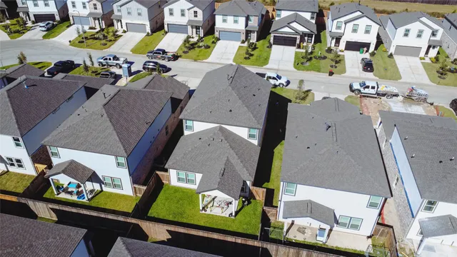 an aerial view of residential houses with outdoor space