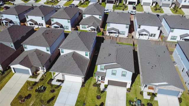 an aerial view of residential houses with outdoor space