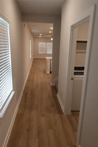 a view of a hallway with wooden floor