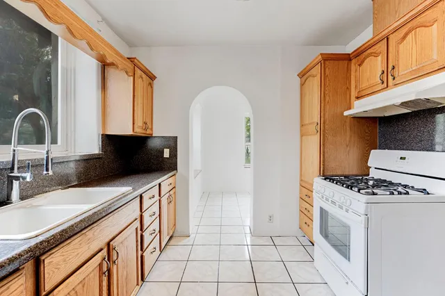 a kitchen with stainless steel appliances a stove a sink and a microwave
