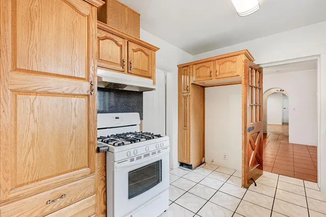 a kitchen with granite countertop a stove a washer and dryer