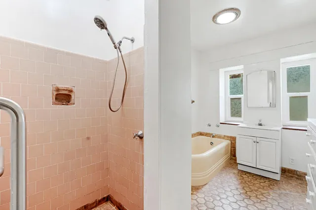 a bathroom with a granite countertop sink a toilet and bathtub