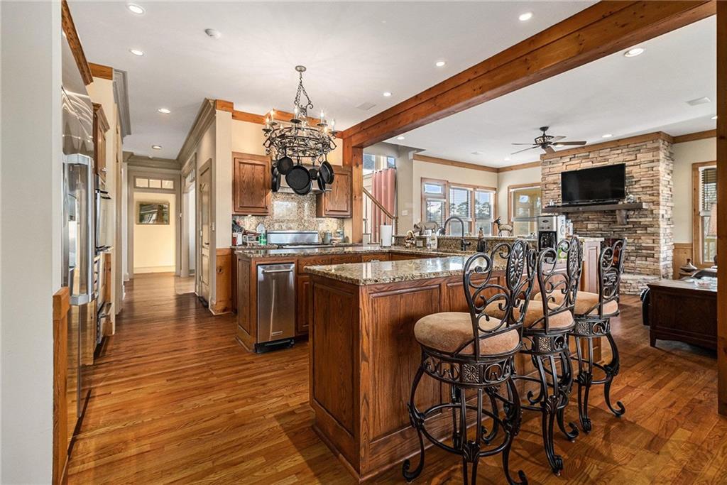 898 Harrison Mill Road Bethlehem, GA 30680 - Photo 39 of 72 a kitchen with stainless steel appliances kitchen island granite countertop a table chairs sink and cabinets
