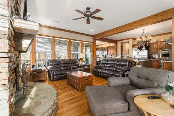 a view of a livingroom with furniture a ceiling fan and windows