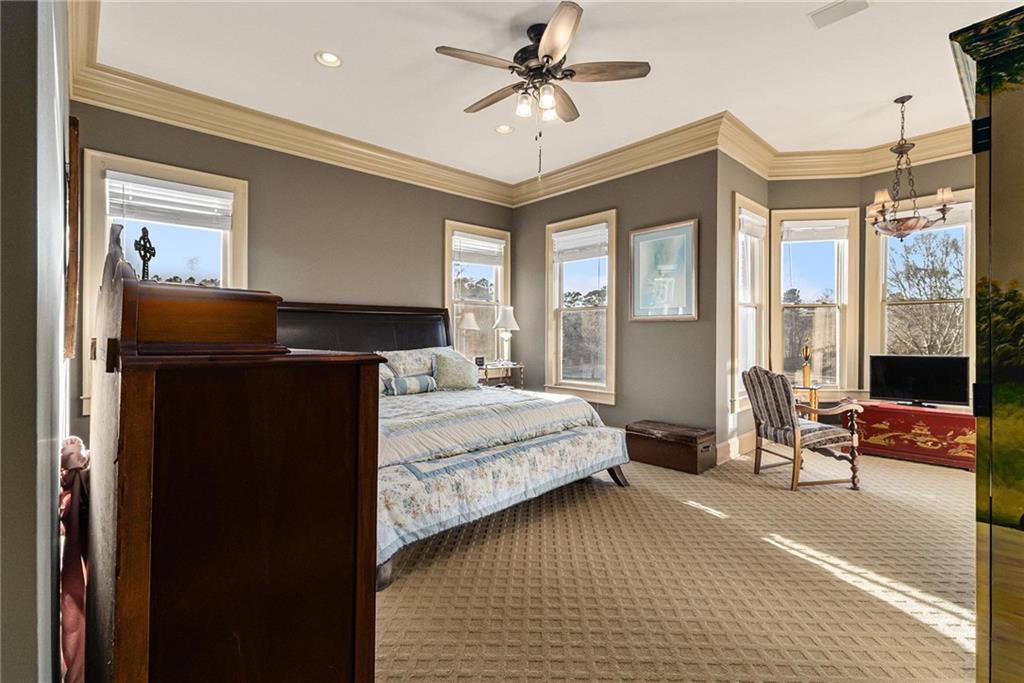 898 Harrison Mill Road Bethlehem, GA 30680 - Photo 51 of 72 a bedroom with a bed and a chandelier