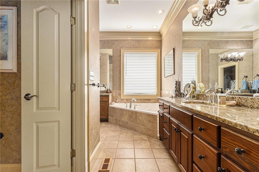 898 Harrison Mill Road Bethlehem, GA 30680 - Photo 57 of 72 a spacious bathroom with a granite countertop sink a mirror and a bathtub