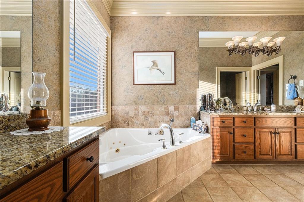 898 Harrison Mill Road Bethlehem, GA 30680 - Photo 58 of 72 a spacious bathroom with a granite countertop tub sink and mirror