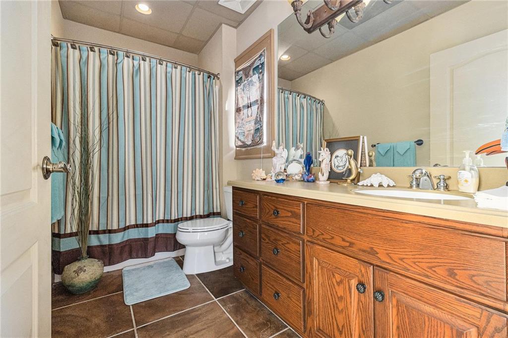 898 Harrison Mill Road Bethlehem, GA 30680 - Photo 65 of 72 a bathroom with a double vanity sink a toilet and a mirror