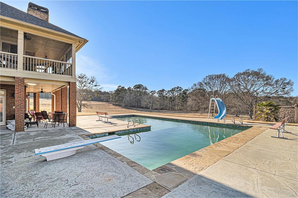 898 Harrison Mill Road Bethlehem, GA 30680 - Photo 8 of 72 a view of a swimming pool with a lounge chair
