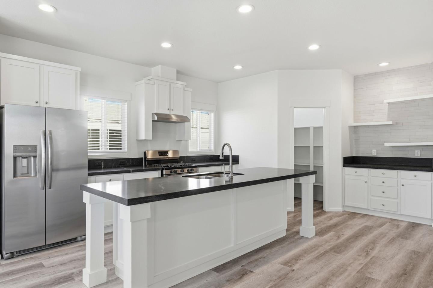 500 West 10th Street, Unit 140 Gilroy, CA 95020 - Photo 12 of 35 a kitchen with stainless steel appliances granite countertop a sink stove and refrigerator