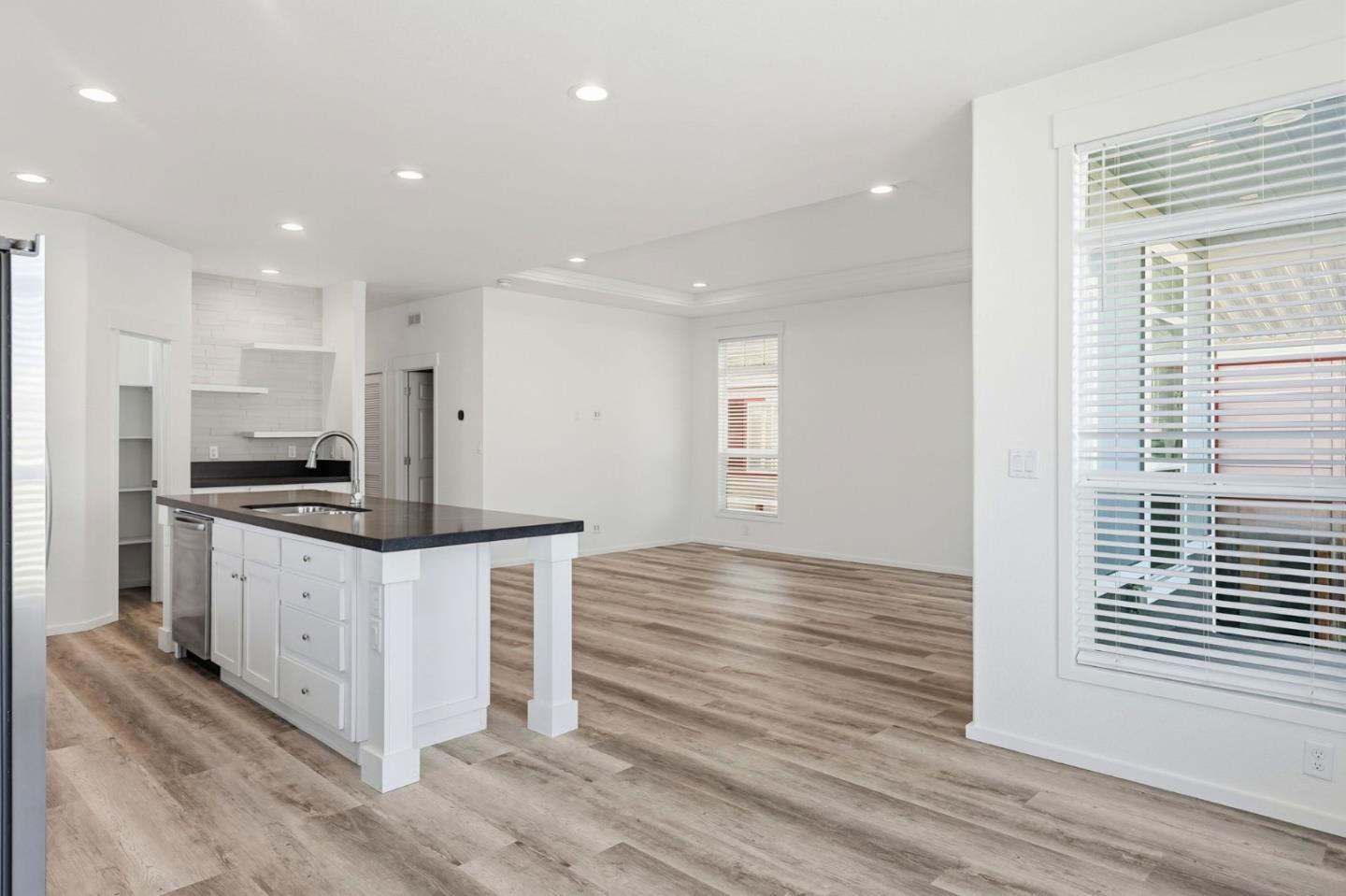 500 West 10th Street, Unit 140 Gilroy, CA 95020 - Photo 13 of 35 a kitchen with stainless steel appliances kitchen island granite countertop a stove a sink and a refrigerator