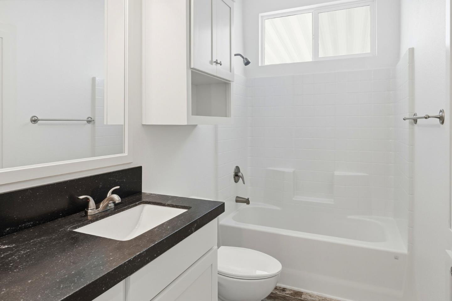 500 West 10th Street, Unit 140 Gilroy, CA 95020 - Photo 26 of 35 a bathroom with a sink toilet a mirror and shower