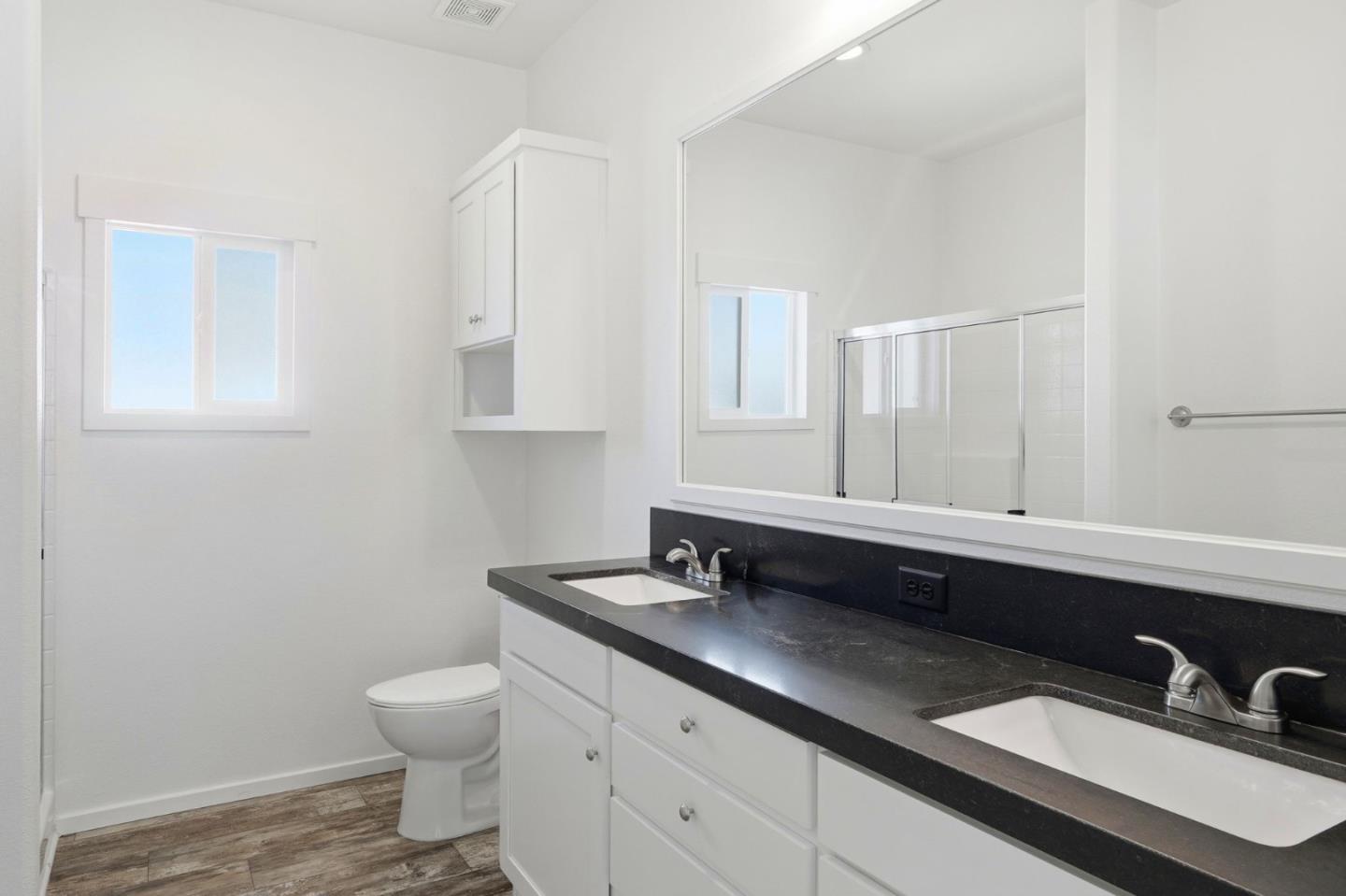 500 West 10th Street, Unit 140 Gilroy, CA 95020 - Photo 27 of 35 a bathroom with a sink double vanity and a toilet