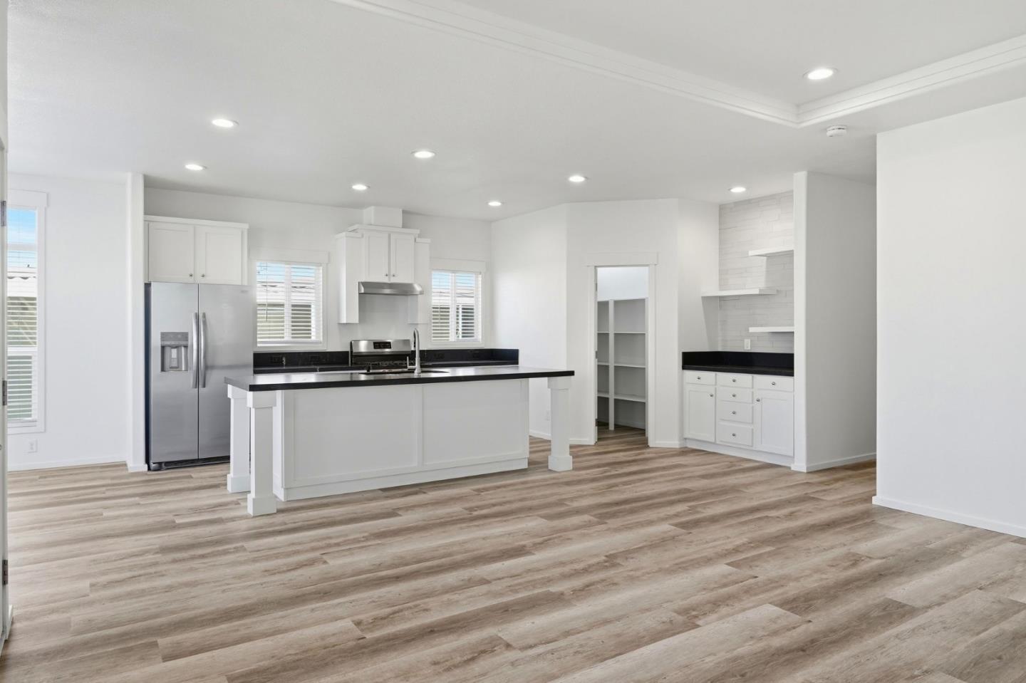 500 West 10th Street, Unit 140 Gilroy, CA 95020 - Photo 9 of 35 a view of kitchen with refrigerator sink and white cabinets
