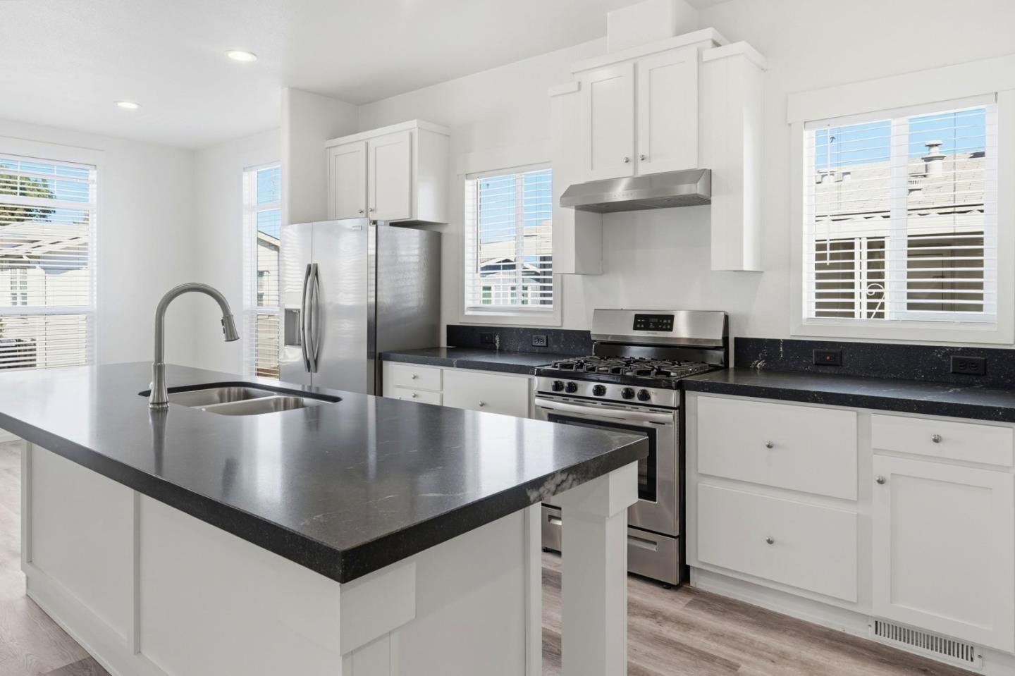 500 West 10th Street, Unit 140 Gilroy, CA 95020 - Photo 10 of 35 a kitchen with stainless steel appliances granite countertop a sink a stove and refrigerator