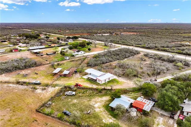 an aerial view of residential houses with yard