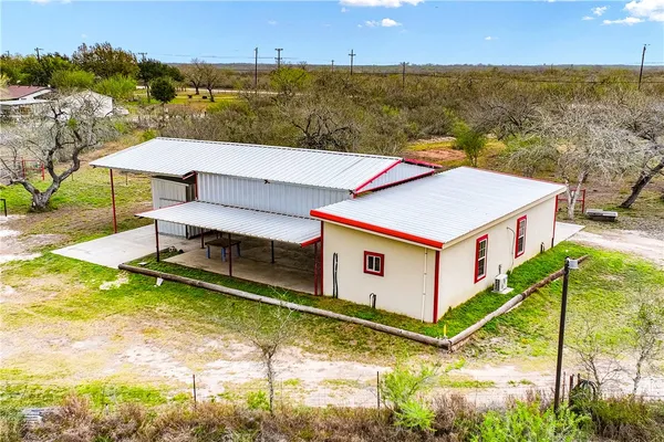 a view of a house with a yard from a lake view