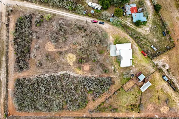 a bedroom with bed a couch and large windows