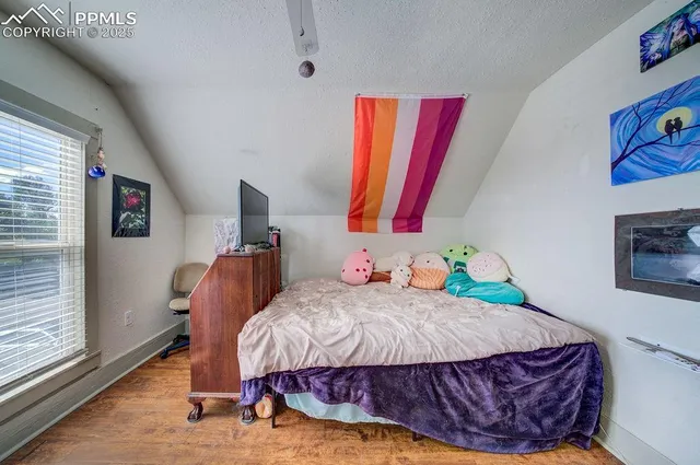 a bedroom with furniture and wooden floor