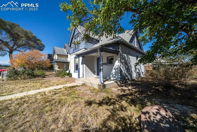 a view of a house with a tree