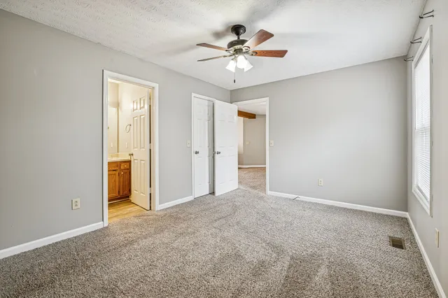 a view of an empty room with a ceiling fan
