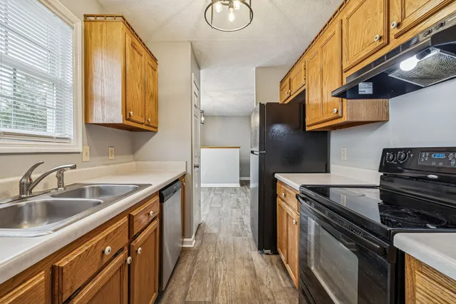 a kitchen with stainless steel appliances granite countertop a sink and a stove