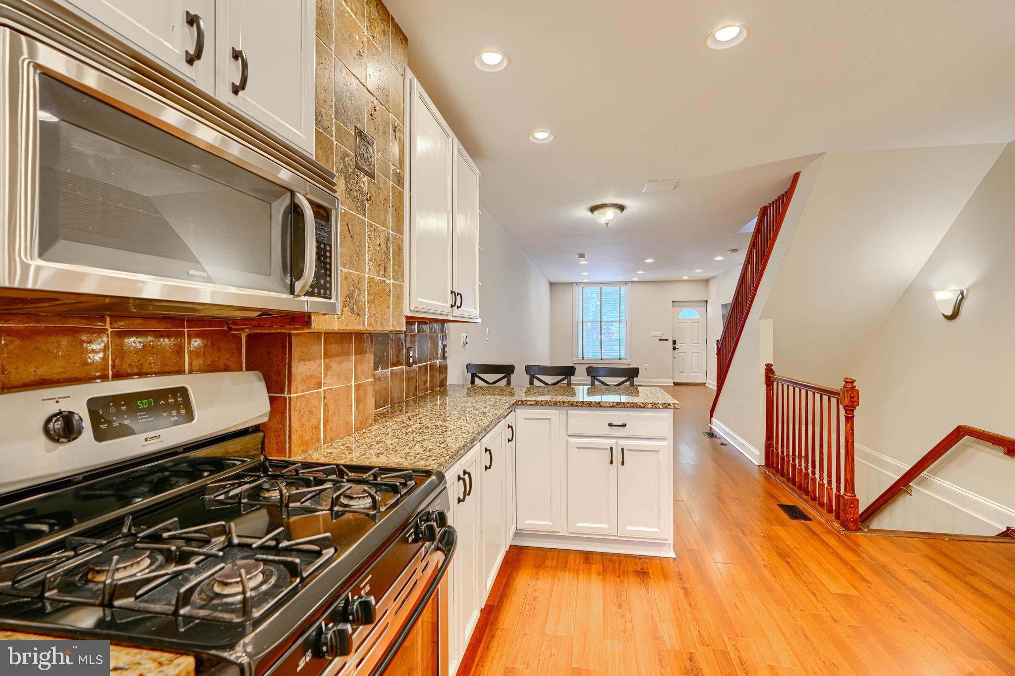 4126 Falls Road Baltimore, MD 21211 - Photo 13 of 35 a kitchen with a stove a sink and a microwave