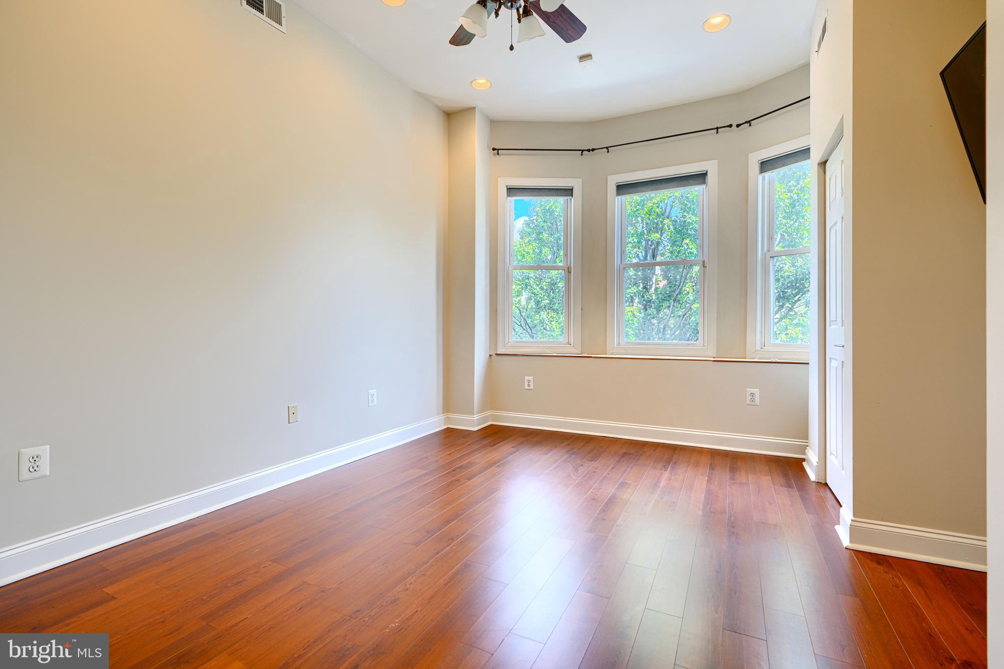 4126 Falls Road Baltimore, MD 21211 - Photo 15 of 35 a view of an empty room with wooden floor and a window