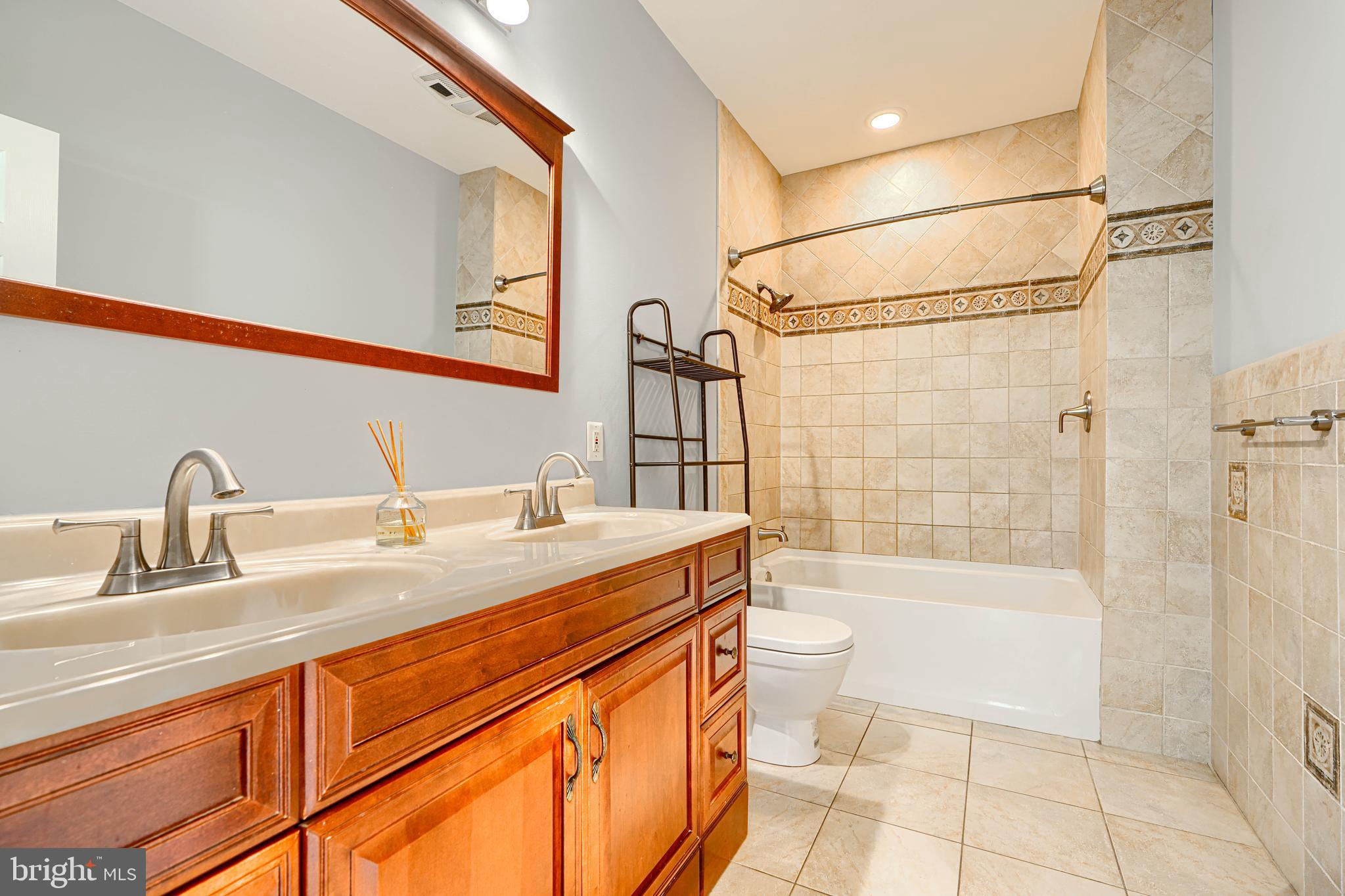 4126 Falls Road Baltimore, MD 21211 - Photo 23 of 35 a bathroom with a sink a toilet and shower
