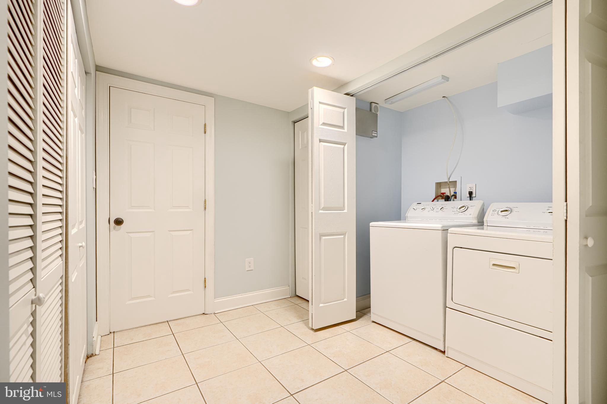 4126 Falls Road Baltimore, MD 21211 - Photo 29 of 35 a utility room with cabinets washer and dryer