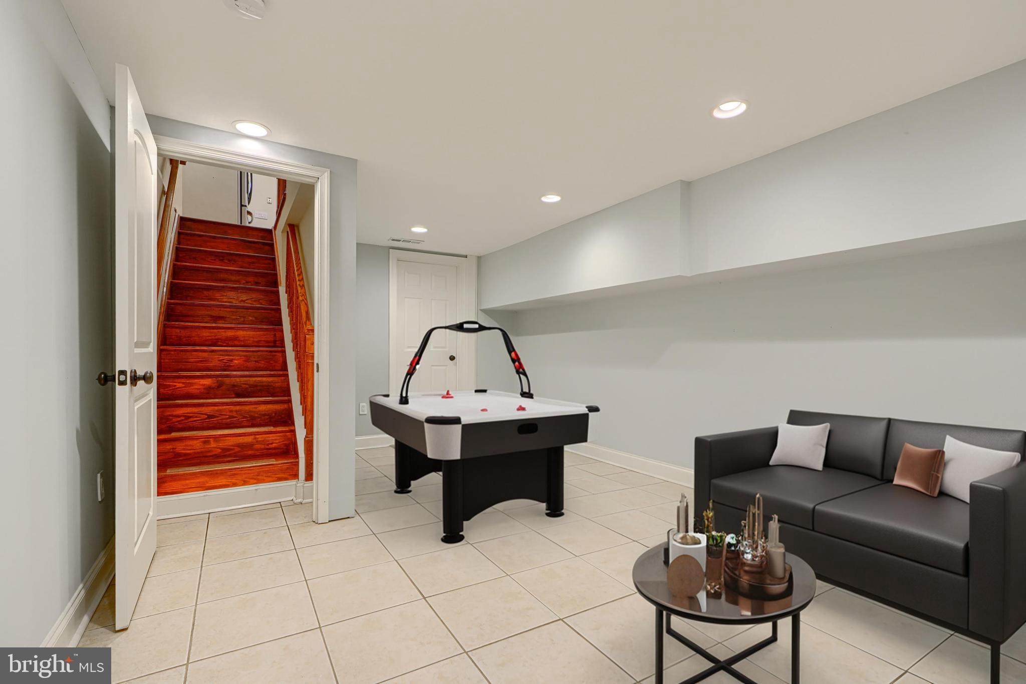 4126 Falls Road Baltimore, MD 21211 - Photo 30 of 35 a living room with furniture a piano and a potted plant