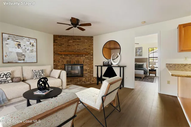 a living room with furniture a rug and a large window