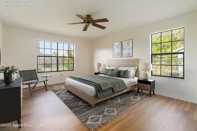 a spacious bedroom with a bed a couch and a window