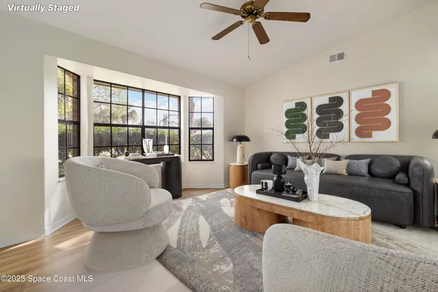 a living room with furniture and a large window