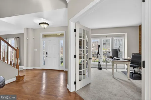 a dining room with furniture a chandelier and a rug