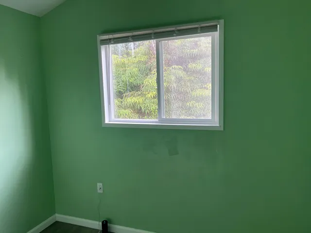 a bathroom with a granite countertop sink and a window