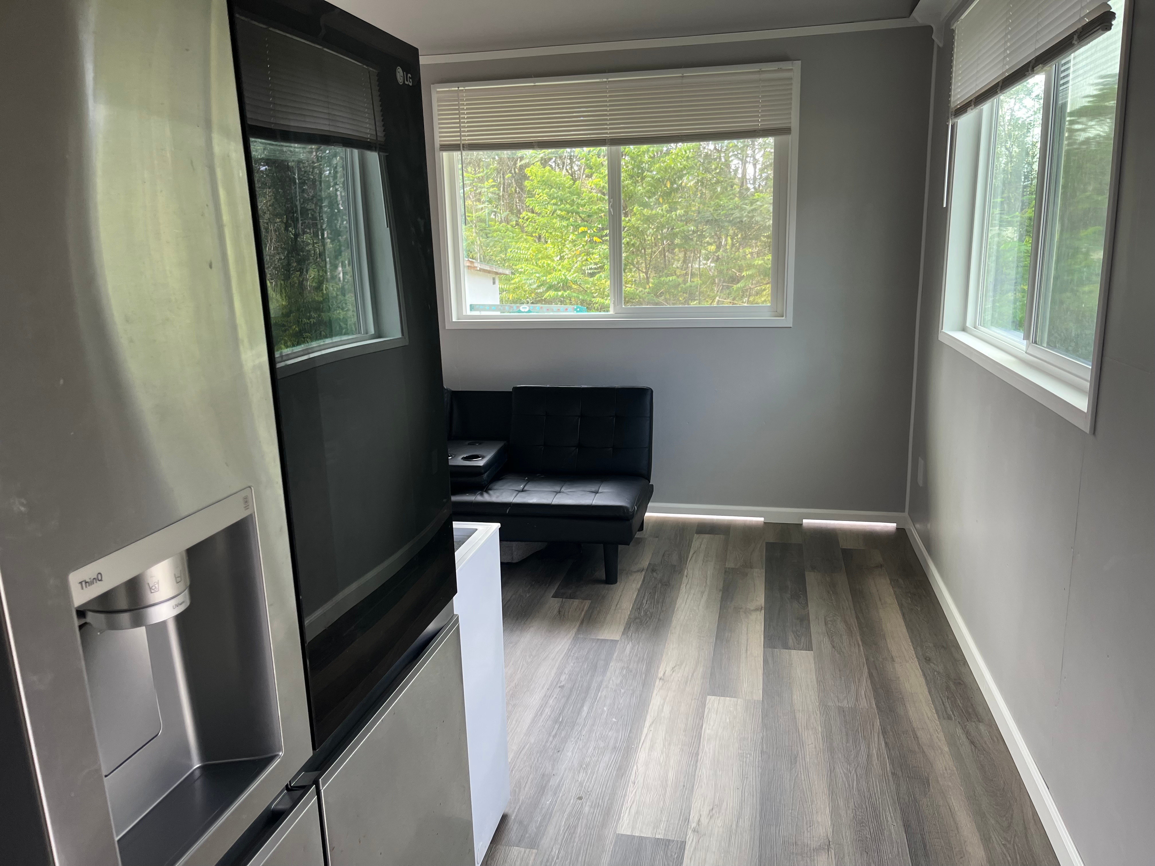 14-3475 Tutu Lane Pahoa, HI 96778 - Photo 4 of 26 a view of an empty room with wooden floor and a window