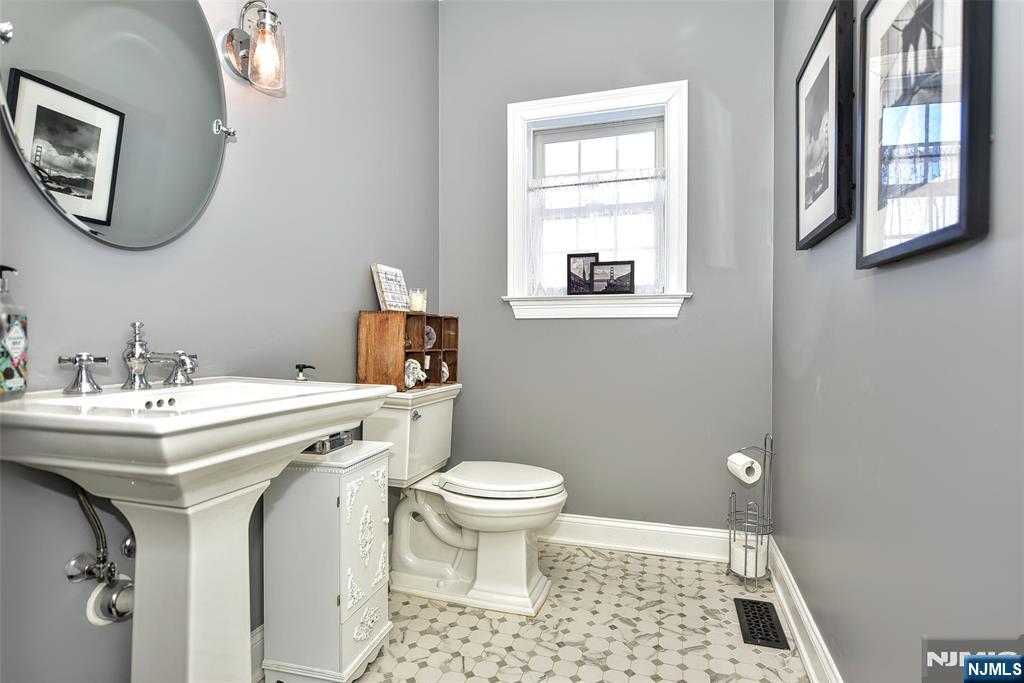 130 Reich Avenue Mahwah, NJ 07430 - Photo 14 of 30 a bathroom with a toilet a sink and a mirror