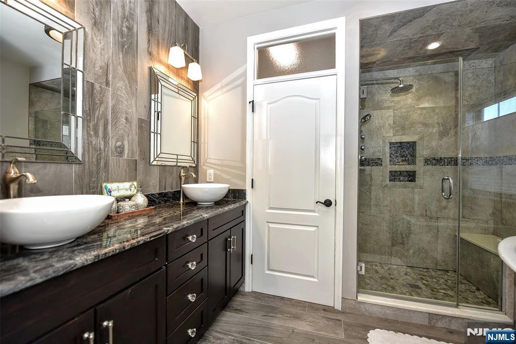 130 Reich Avenue Mahwah, NJ 07430 - Photo 20 of 30 a spacious bathroom with a granite countertop sink and a mirror