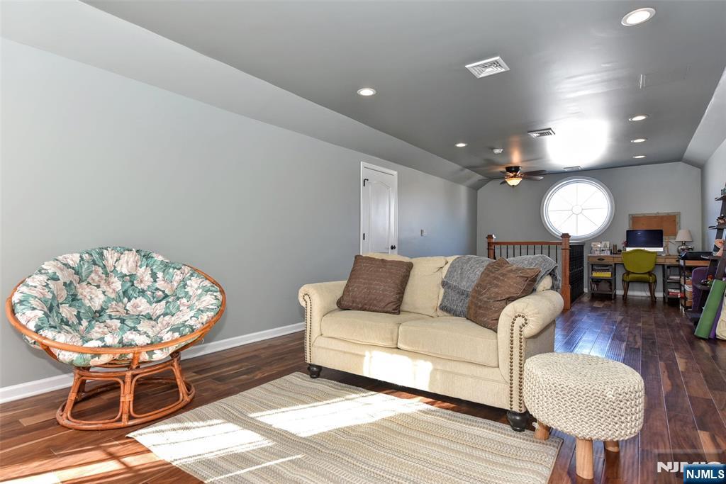 130 Reich Avenue Mahwah, NJ 07430 - Photo 24 of 30 a living room with furniture a table and a chandelier