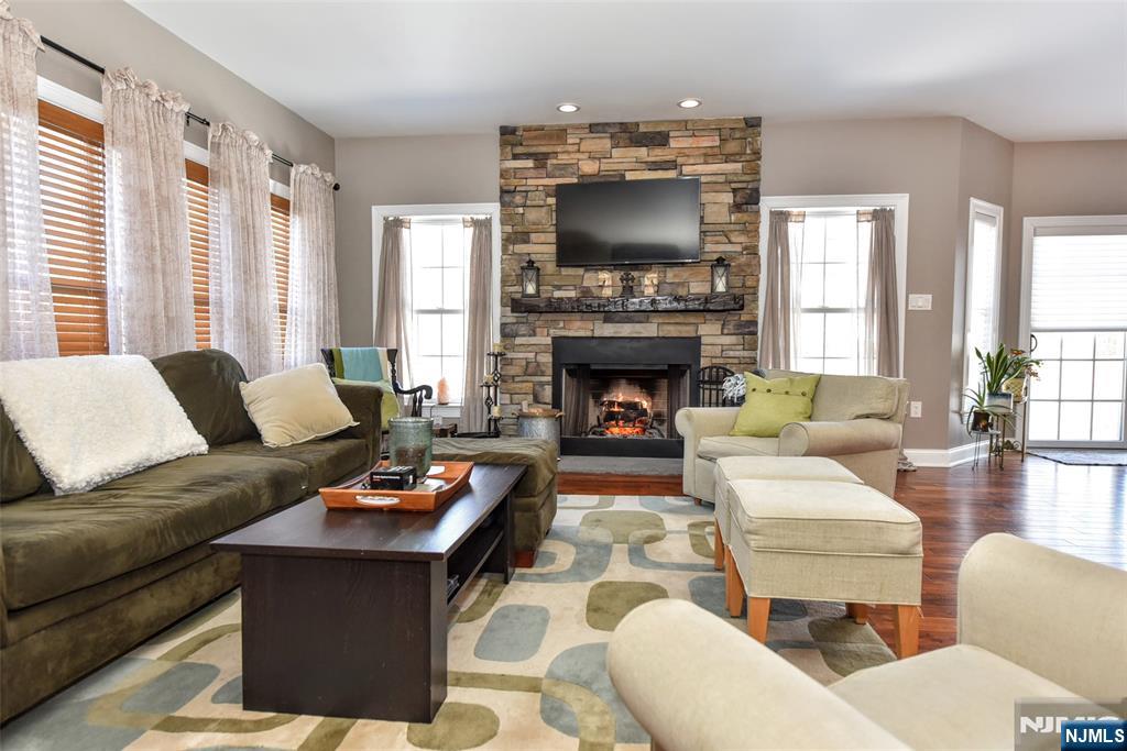 130 Reich Avenue Mahwah, NJ 07430 - Photo 6 of 30 a living room with furniture a fireplace and a flat screen tv
