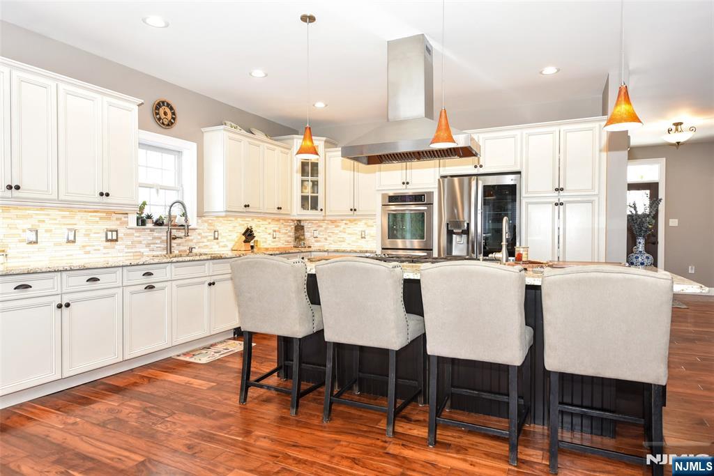 130 Reich Avenue Mahwah, NJ 07430 - Photo 8 of 30 a dining area with a table chairs sink and wooden floor