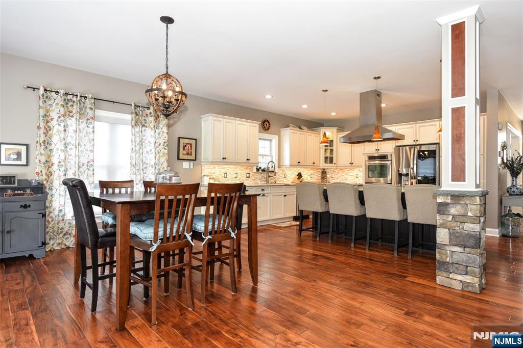 130 Reich Avenue Mahwah, NJ 07430 - Photo 10 of 30 a view of a dining room and livingroom with furniture wooden floor a chandelier