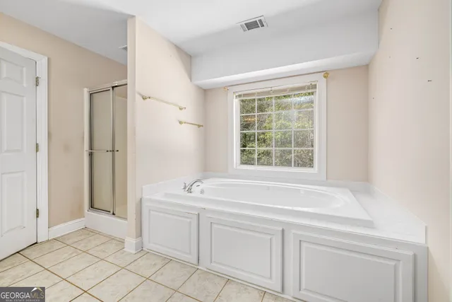 a spacious bathroom with a sink mirror and a bathtub