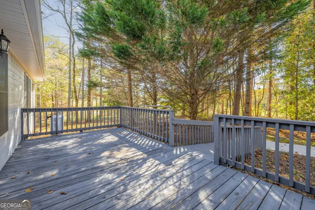 a view of a deck with wooden floor and wooden fence